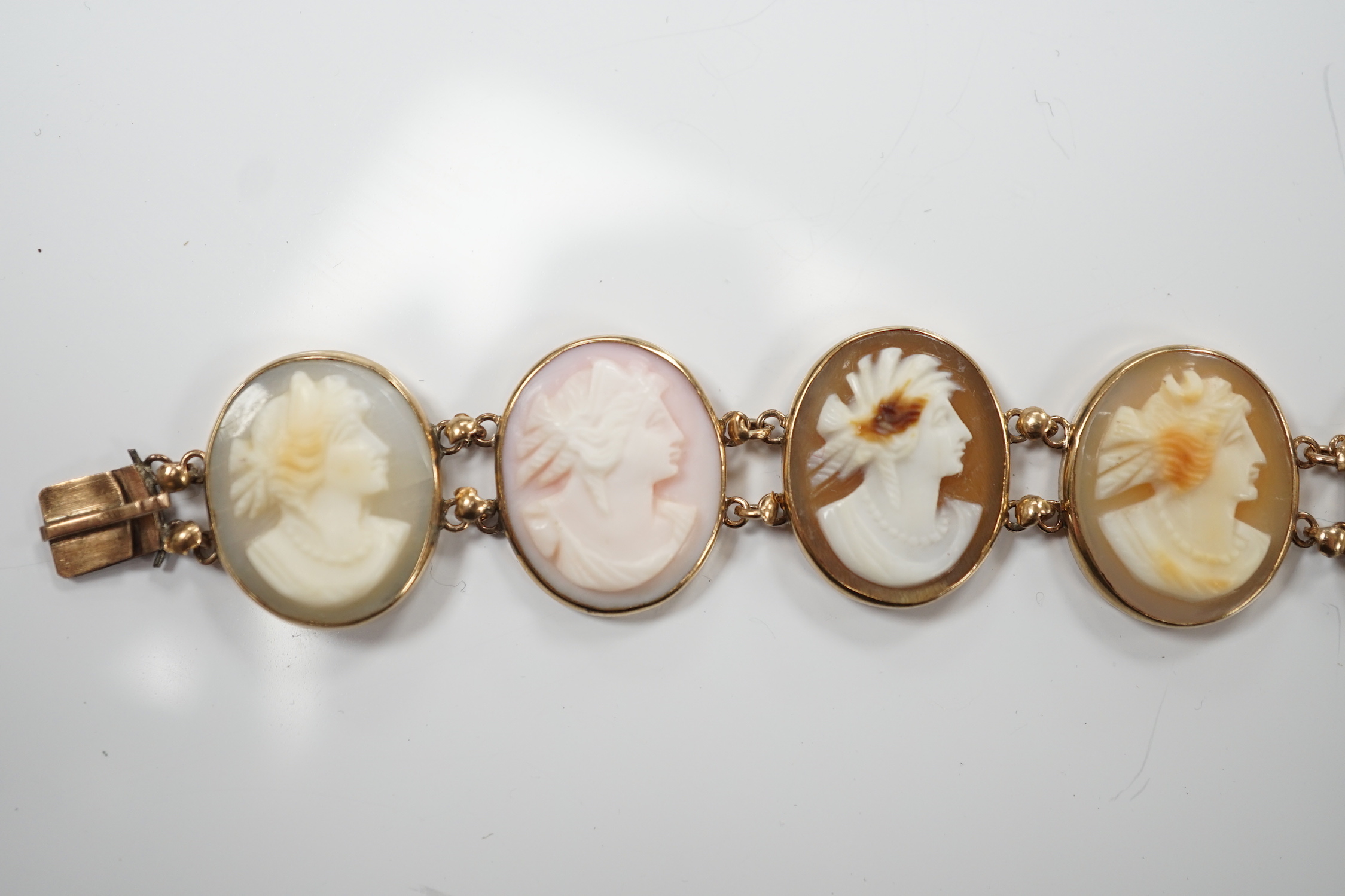 A yellow metal mounted ten stone oval cameo shell set bracelet, each carved with bust of a lady to sinister, 16cm, gross weight 13.9 grams.